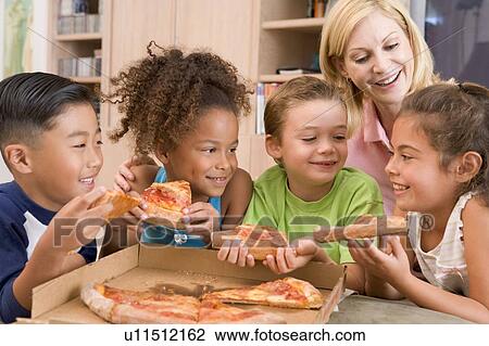 Four young children indoors with woman eating pizza smiling View Large Photo Image Stock Image - Four young children indoors with woman eating pizza smiling. Fotosearch