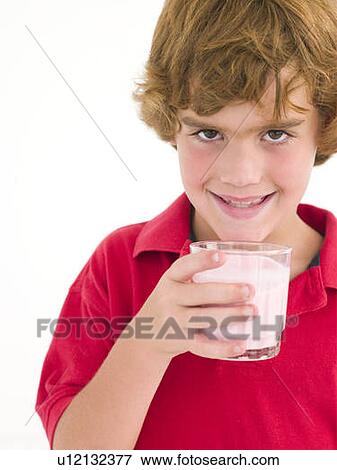Stock Photo - Young boy with glass of milk smiling. Fotosearch