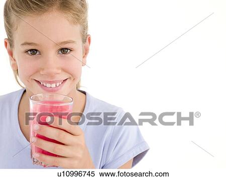 Stock Photography - Young girl with glass of juice smiling. Fotosearch