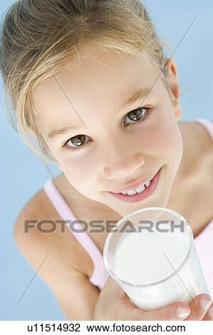 Young girl with glass of milk smiling View Large Photo Image Stock Image - Young girl with glass of milk smiling. Fotosearch