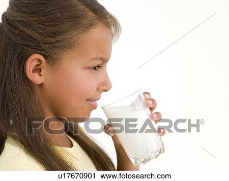Young girl with glass of milk smiling View Large Photo Image Stock Image - Young girl with glass of milk smiling. Fotosearch