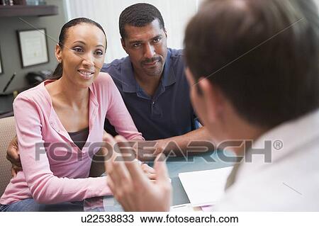 Stock Image - Couple in consultation at IVF clinic (selective focus). Fotosearch
