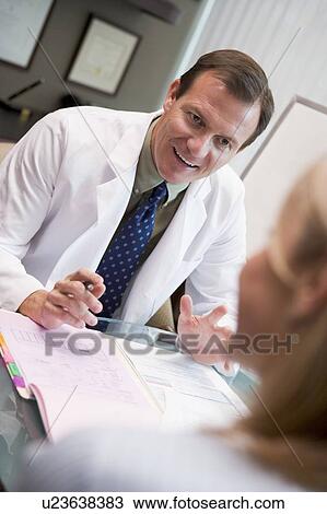 Stock Image - Doctor in consultation with woman at IVF clinic (selective focus). Fotosearch