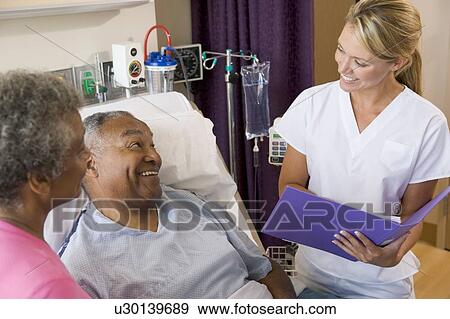 Stock Photo - Doctor Making Notes About Patient. Fotosearch