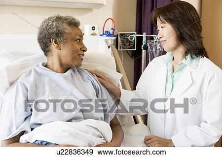 Doctor Talking To Senior Woman View Large Photo Image Stock Photo - Doctor Talking To Senior Woman. Fotosearch