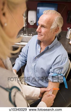 Stock Photo - Middle Aged Man Having Blood Test Done. Fotosearch