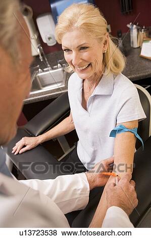 Middle Aged Woman Having Blood Test Done View Large Photo Image Stock Photo - Middle Aged Woman Having Blood Test Done. Fotosearch