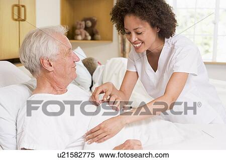 Stock Photography - Nurse Helping Senior Man. Fotosearch