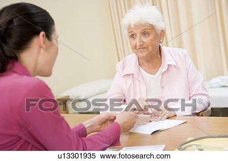 Stock Photography - Woman in doctor's office frowning. Fotosearch