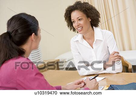 Woman in doctor's office smiling View Large Photo Image Stock Image - Woman in doctor's office smiling. Fotosearch