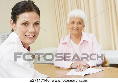 Woman in doctor's office smiling View Large Photo Image Stock Photograph - Woman in doctor's office smiling. Fotosearch