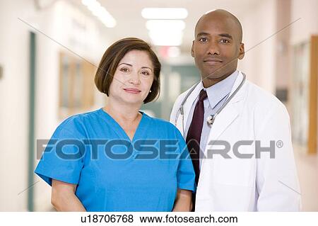 A Doctor And Nurse Standing In A Hospital Corridor View Large Photo Image Stock Photo - A Doctor And Nurse Standing In A Hospital Corridor. Fotosearch