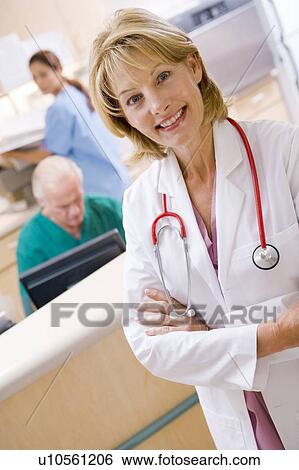A Doctor And Nurses In The Reception Area Of A Hospital View Large Photo Image Stock Photograph - A Doctor And Nurses In The Reception Area Of A Hospital. Fotosearch