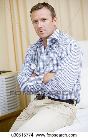 A Doctor Sitting On A Hospital Bed View Large Photo Image Picture - A Doctor Sitting On A Hospital Bed. Fotosearch