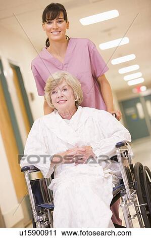A Nurse Pushing A Senior Woman In A Wheelchair Down A Hospital Corridor View Large Photo Image Stock Image - A Nurse Pushing A Senior Woman In A Wheelchair Down A Hospital Corridor. Fotosearch