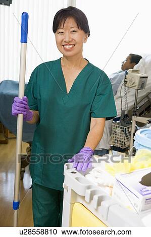 Stock Image - An Orderly Mopping The Floor In A Hospital Ward. Fotosearch