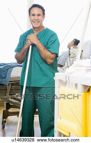 Stock Photo - An Orderly Mopping The Floor In A Hospital Ward. Fotosearch
