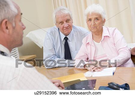 Stock Photograph - Couple in doctor's office frowning. Fotosearch