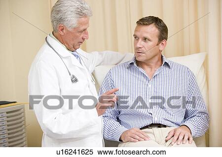 Doctor giving man checkup in exam room View Large Photo Image Stock Photography - Doctor giving man checkup in exam room. Fotosearch