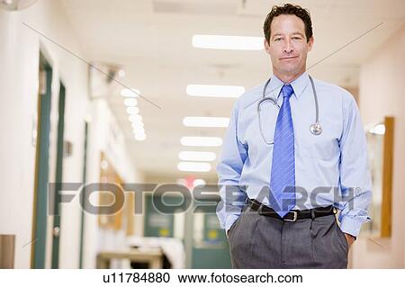 Stock Image - Doctor Standing In A Hospital Corridor. Fotosearch