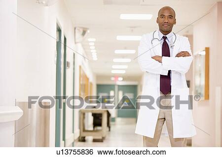 Stock Photograph - Doctor Standing In A Hospital Corridor. Fotosearch