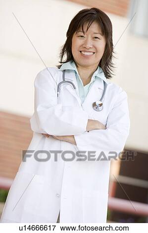 Stock Photo - Doctor Standing Outside A Hospital. Fotosearch