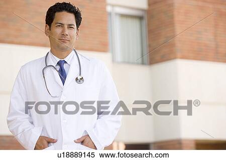 Stock Photography - Doctor Standing Outside A Hospital. Fotosearch