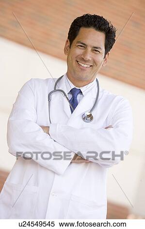 Stock Photography - Doctor Standing Outside A Hospital. Fotosearch