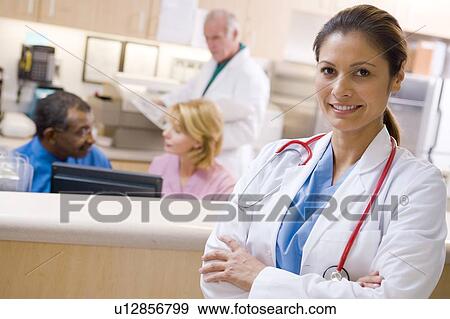 Stock Photo - Doctors And Nurses At The Reception Area Of A Hospital. Fotosearch