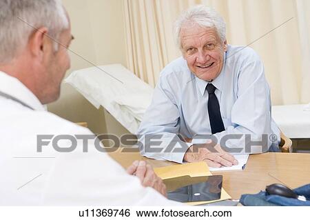 Stock Photograph - Man in doctor's office smiling. Fotosearch