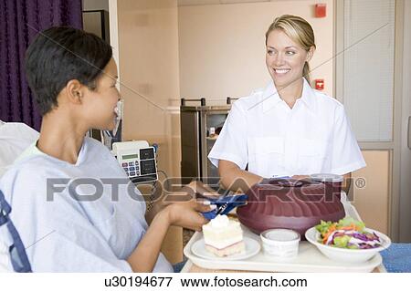 Nurse Serving A Patient A Meal In Her Bed View Large Photo Image Stock Photo - Nurse Serving A Patient A Meal In Her Bed. Fotosearch