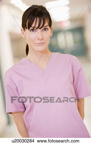 Picture - Nurse Standing In A Hospital Corridor. Fotosearch