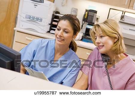 Stock Photo - Nurses At The Reception Area In A Hospital. Fotosearch
