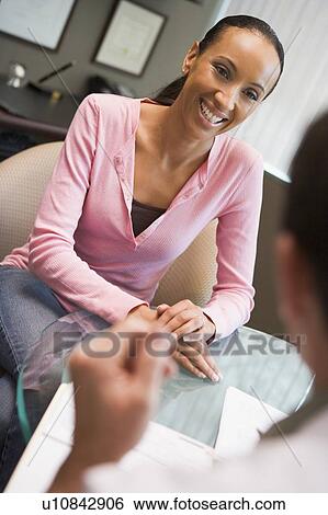 Stock Photograph - Woman in consultation at IVF clinic (selective focus). Fotosearch
