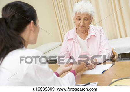 Woman in doctor's office frowning View Large Photo Image Stock Photo - Woman in doctor's office frowning. Fotosearch