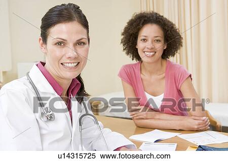 Woman in doctor's office smiling View Large Photo Image Stock Photography - Woman in doctor's office smiling. Fotosearch