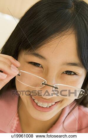 Stock Photo - Girl Looking Through New Glasses. Fotosearch