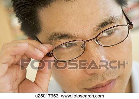 Stock Image - Man Looking Through New Glasses. Fotosearch
