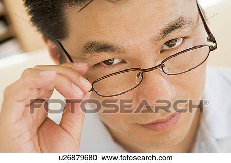 Stock Image - Man Looking Through New Glasses. Fotosearch
