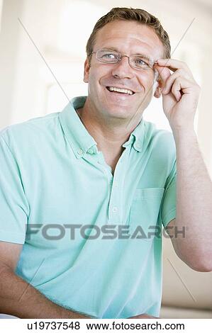 Stock Photo - Man Looking Through New Glasses. Fotosearch