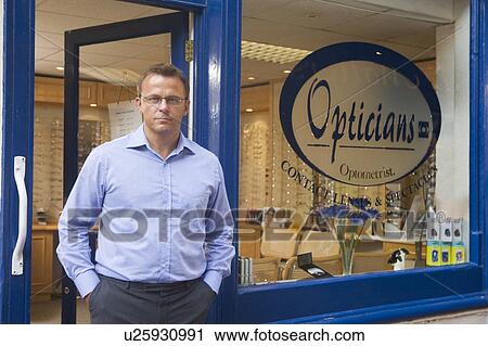 Man standing at front entrance of optometrists View Large Photo Image Stock Image - Man standing at front entrance of optometrists. Fotosearch