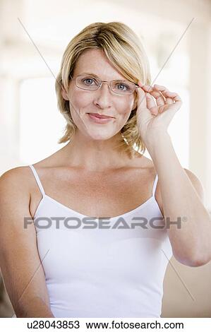 Stock Image - Woman Looking Through New Glasses. Fotosearch