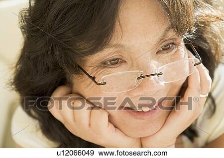 Stock Photo - Woman Looking Through New Glasses. Fotosearch