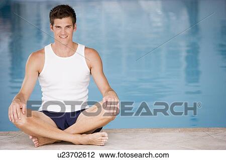 Man sitting poolside smiling View Large Photo Image Stock Image - Man sitting poolside smiling. Fotosearch