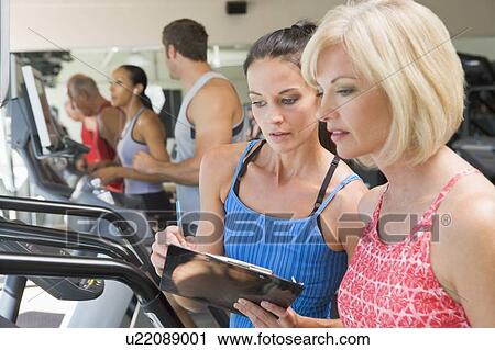 Personal Trainer Instructing Woman On Treadmill View Large Photo Image Stock Image - Personal Trainer Instructing Woman On Treadmill. Fotosearch