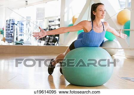 Stock Photography - Woman Balancing On Swiss Ball. Fotosearch