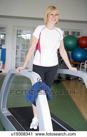 Woman Running On Treadmill At Gym View Large Photo Image Stock Image - Woman Running On Treadmill At Gym. Fotosearch