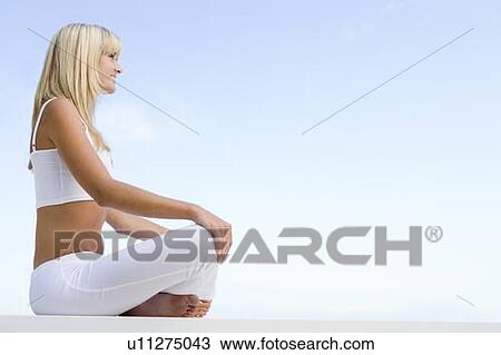 Woman sitting and meditating outdoors View Large Photo Image Stock Image - Woman sitting and meditating outdoors. Fotosearch