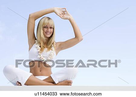 Woman sitting and meditating outdoors View Large Photo Image Stock Image - Woman sitting and meditating outdoors. Fotosearch