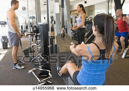 Stock Photo - Group Of People Weight Training At Gym. Fotosearch